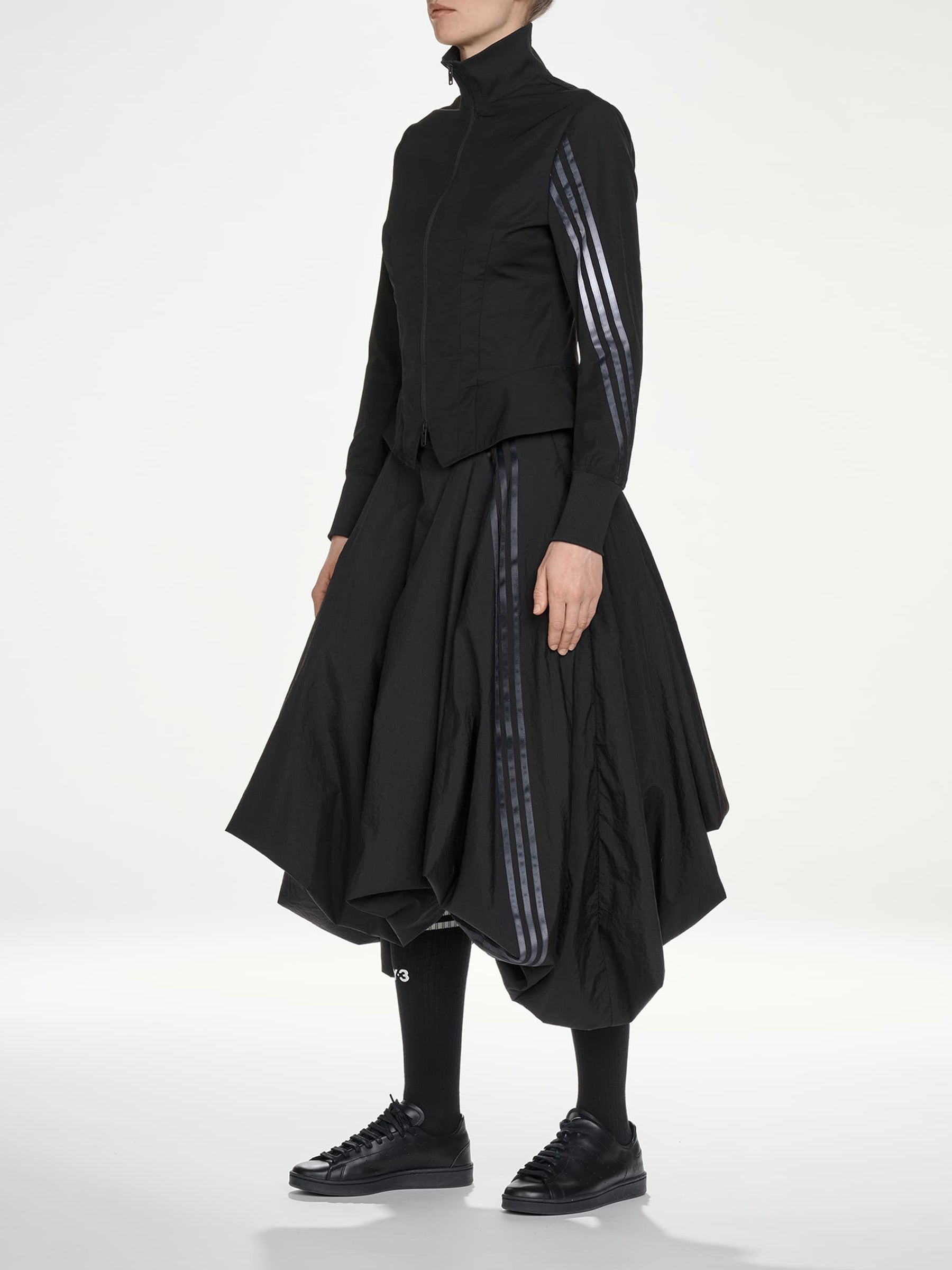 Y-3 AW26 3-Stripes Nylon Track Top in Black - three-quarter view on model showing contrast 3-Stripes at sleeve and fitted nylon construction