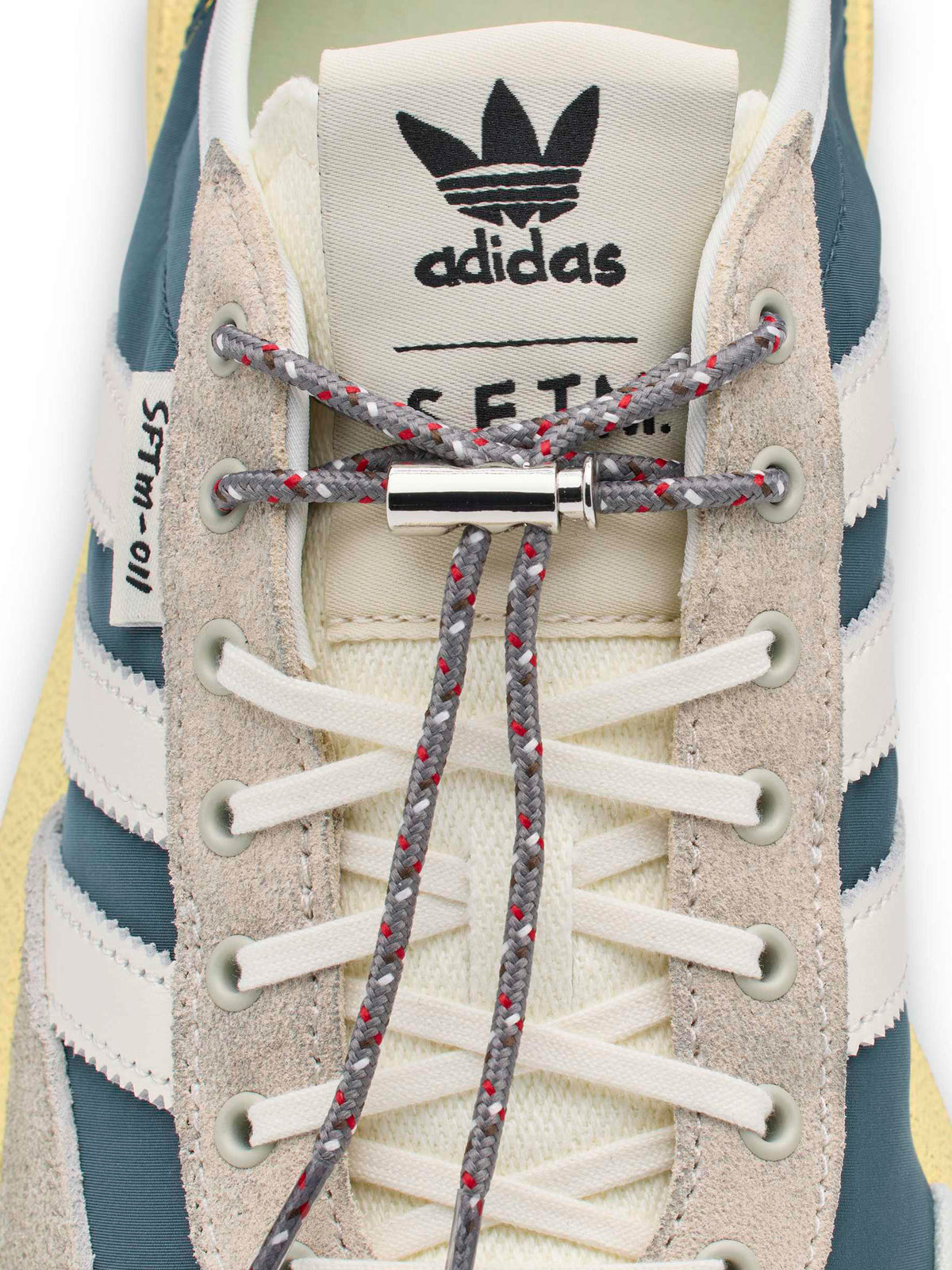 Adidas x Song for the Mute SL 72 Pro SFTM close-up showing tongue branding and multicolour lacing detail