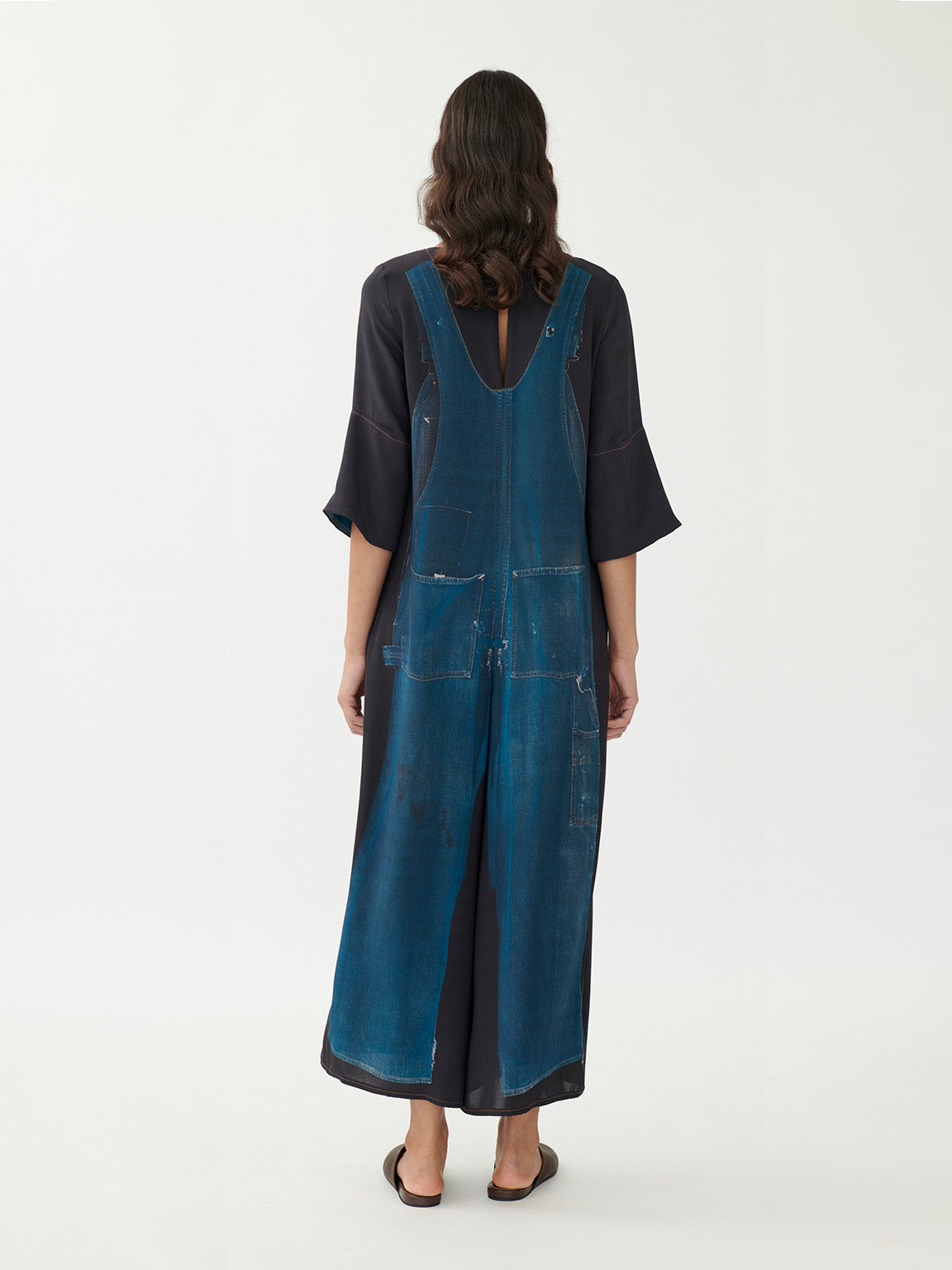 Annette Görtz printed denim overall, side view showing wide-leg silhouette and fluid drape in motion