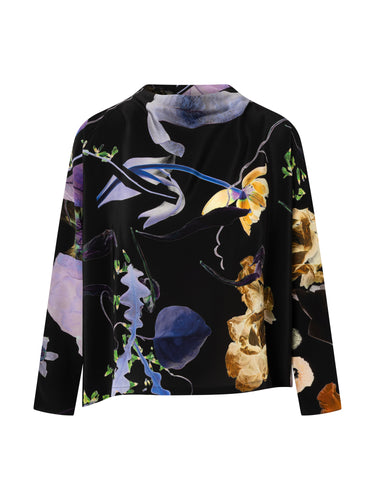 Front view of the Anntian Asymmetric Top in Print 07, featuring a dark floral print in black, purple, and beige, with a high neck, long sleeves, relaxed fit, and curved hem.