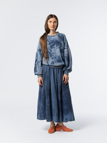 Woman wearing a blue tie-dye outfit from Anntian on a white background