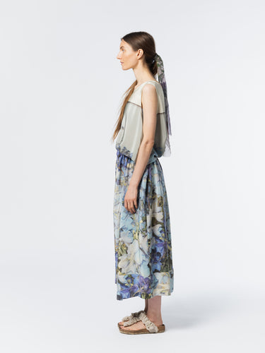 Side view of model wearing the Anntian Silkdress in Print Q, highlighting the relaxed silhouette and elastic drawstring waist in a multicolour floral print silk with blue tones