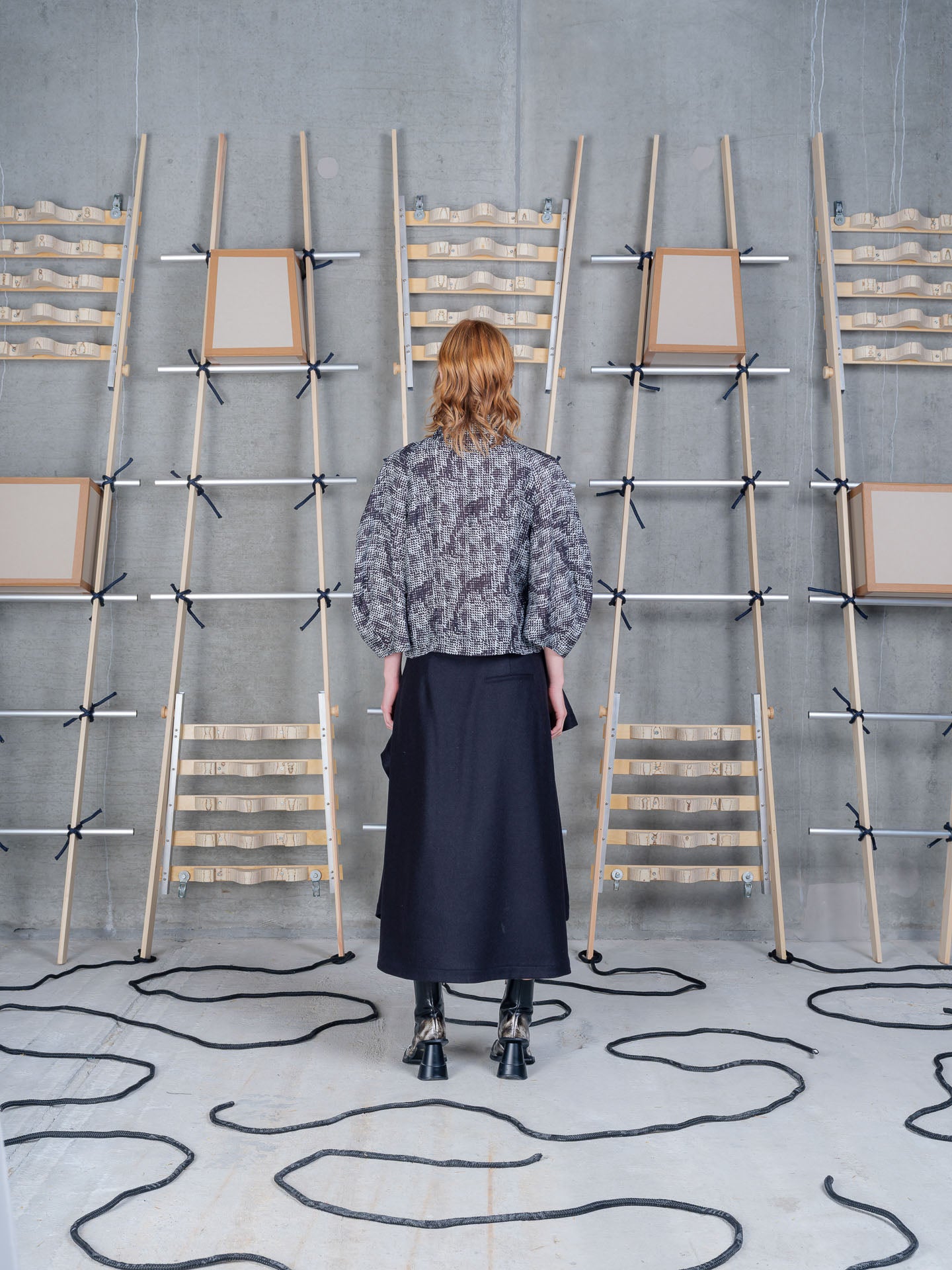 Model wearing Blanket Skirt in Blue Wool Checks by Henrik Vibskov back view