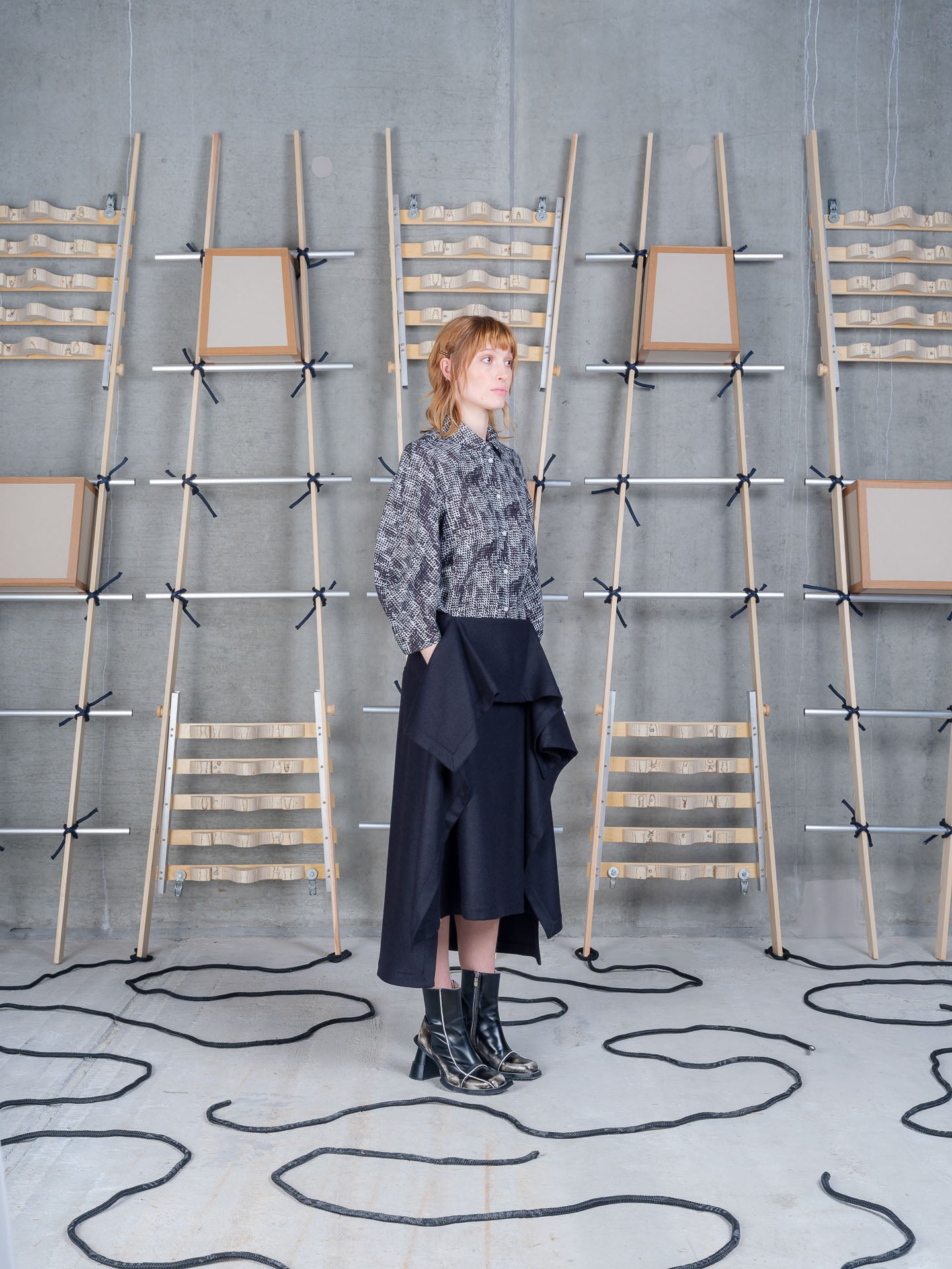Model wearing Blanket Skirt in Blue Wool Checks by Henrik Vibskov side view