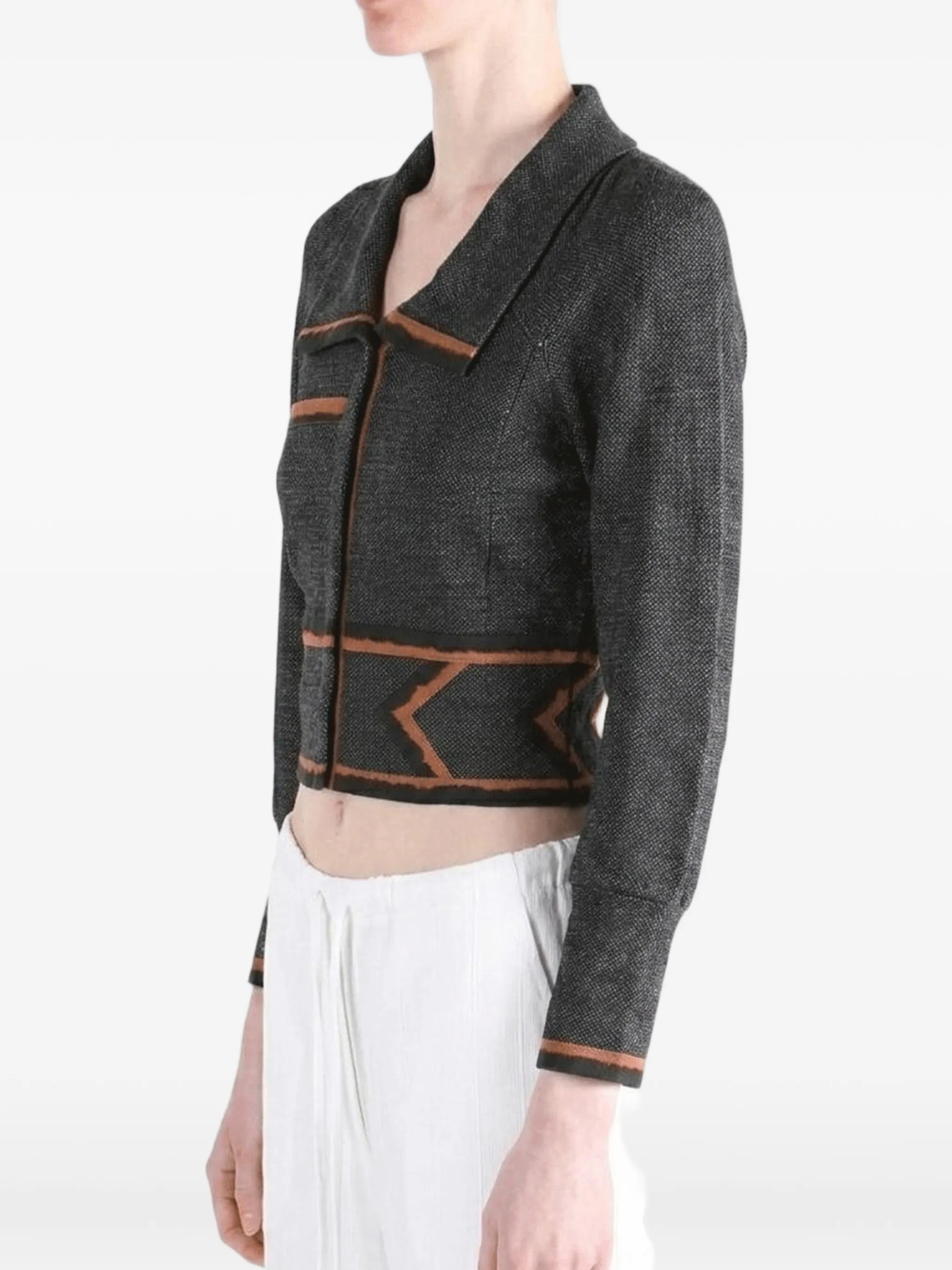 Side view of the model wearing the Kiko Kostadinov Compass Jacket in Abyss Black.