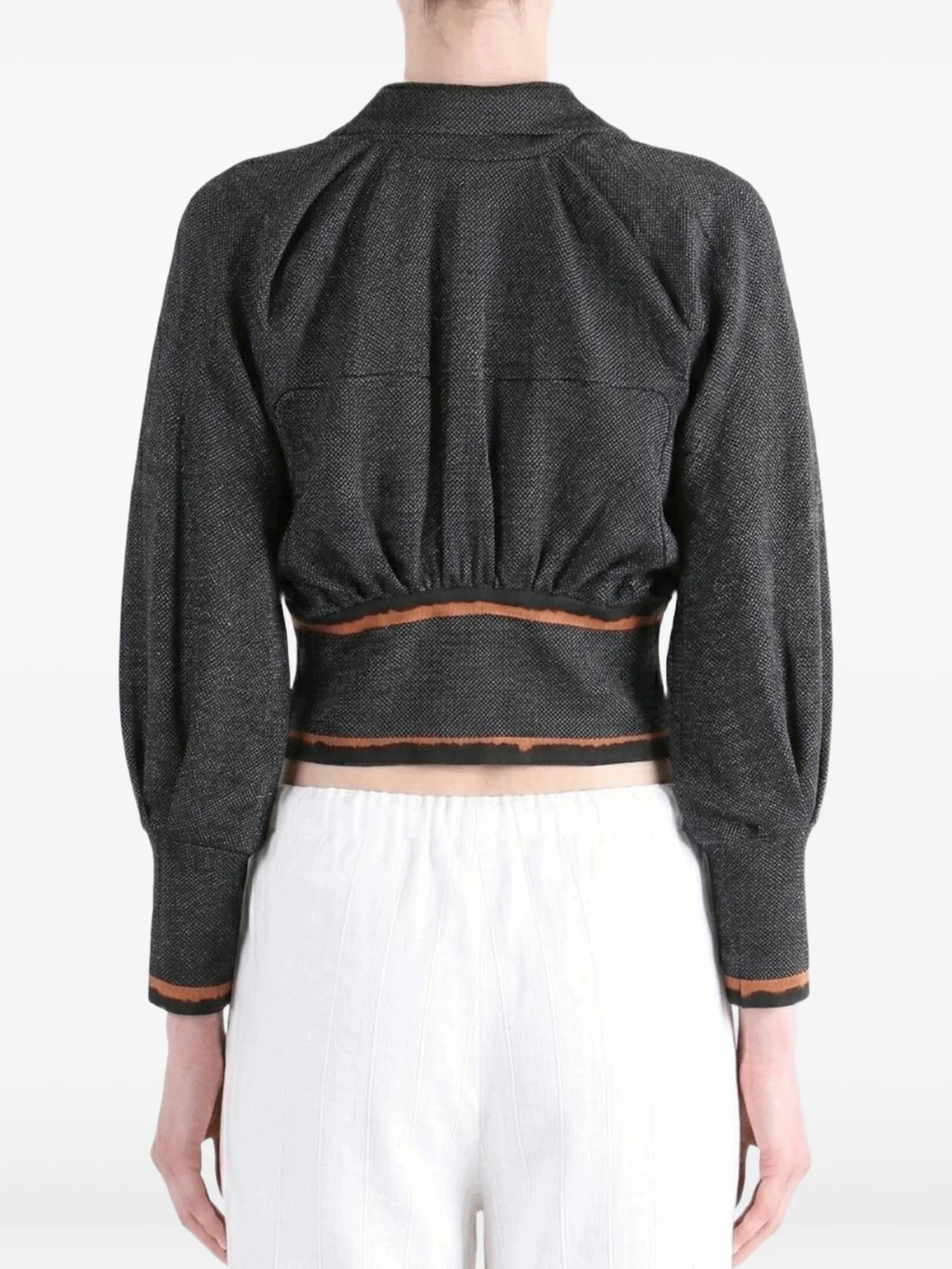 Rear view of the model wearing the Kiko Kostadinov Compass Jacket in Abyss Black.