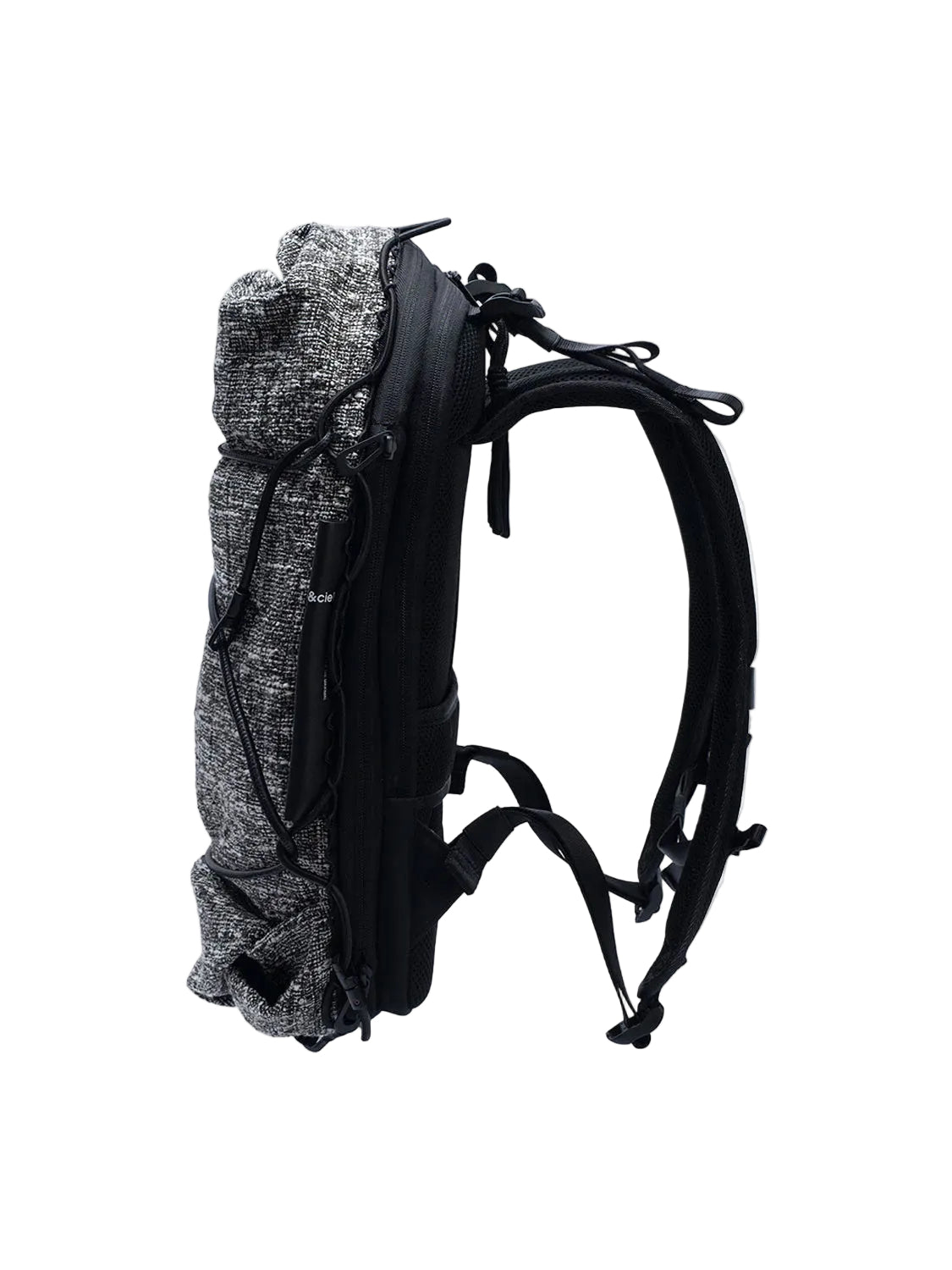 Side view of Côte & Ciel Ladon Tweed in Black & Cream backpack showing slim profile, padded straps and zippered construction