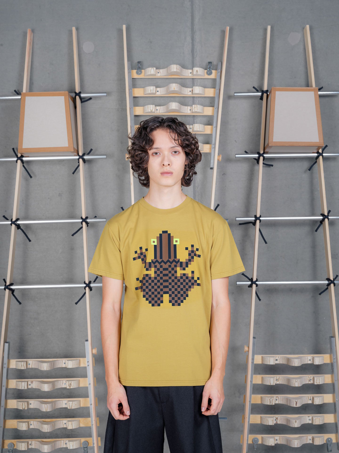 Model wearing Henrik Vibskov Cross Stitch Tee in Amer Green, front view.