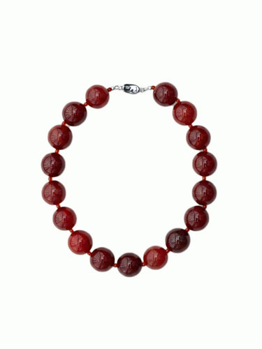 Round and red carnelian necklace with silver clasp from De Silang on a white background