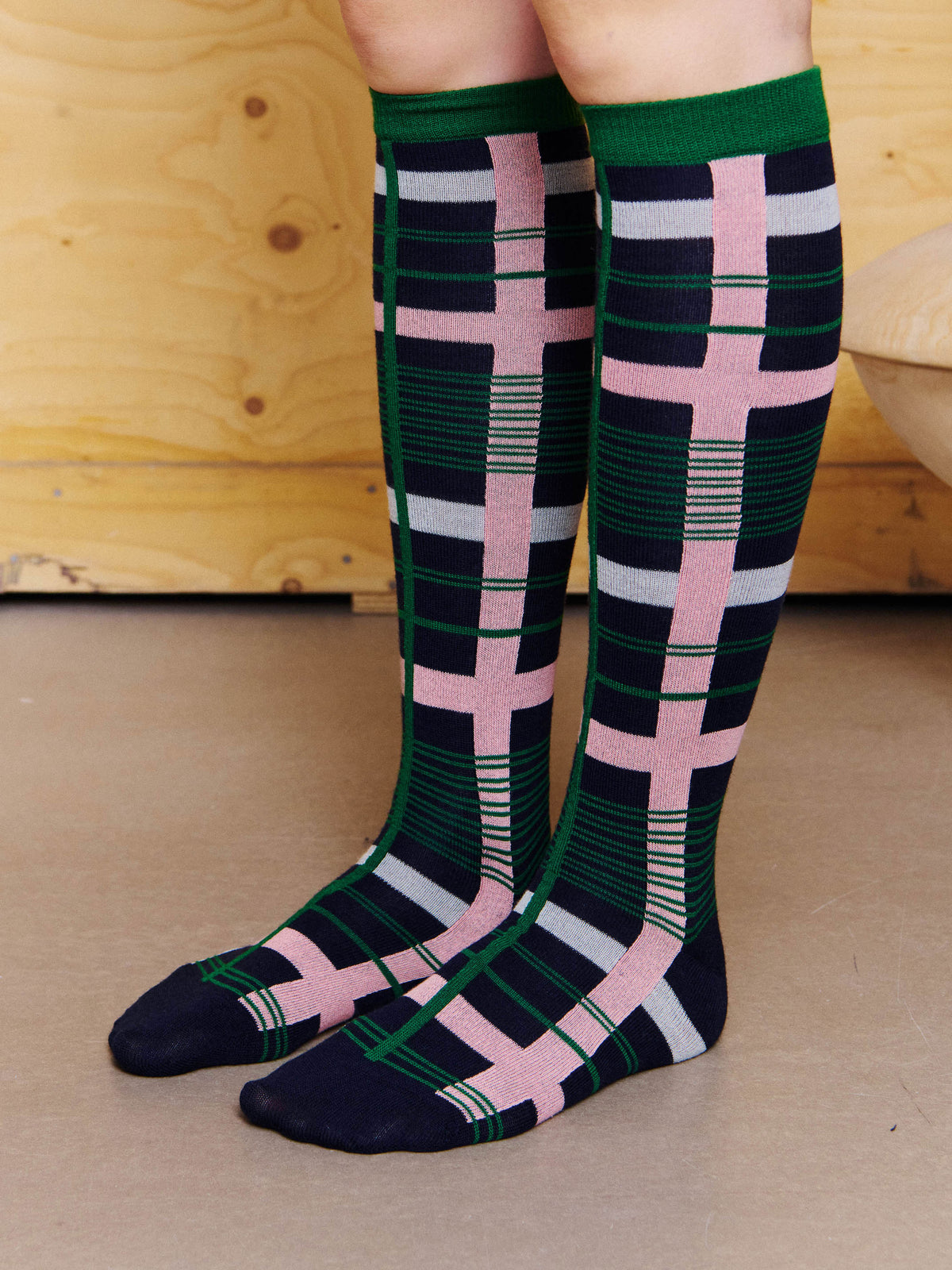 Henrik Vibskov Archive Socks in Green Pink Archive worn side view, showing the pink vertical stripe, green check lines and reinforced toe.