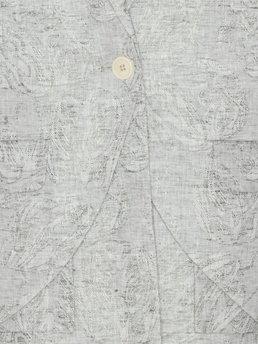 Close-up highlighting the grey floral textured fabric, layered detailing, and single-button closure of the blazer.