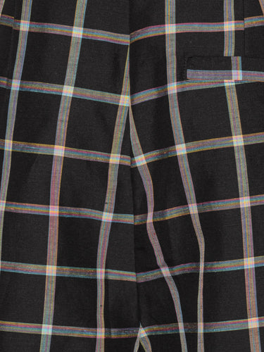 Close-up packshot of the Claus Shorts in Black Checks from Henrik Vibskov Spring/Summer 2026 Studio Collection, focusing on the multicoloured check fabric, waistband, and front button detailing.