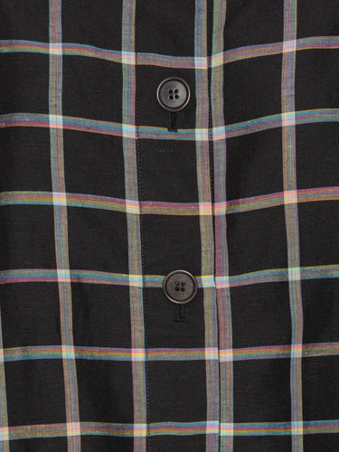 Close-up packshot of the Cover Coat in Black Checks from Henrik Vibskov Spring/Summer 2026 Studio Collection, highlighting the check fabric, collar, button placket, and detachable sleeve detailing.