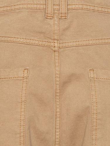 Close-up of the Curved Denim Pants showing the dark beige denim texture, waistband with belt loops, and pocket detailing.