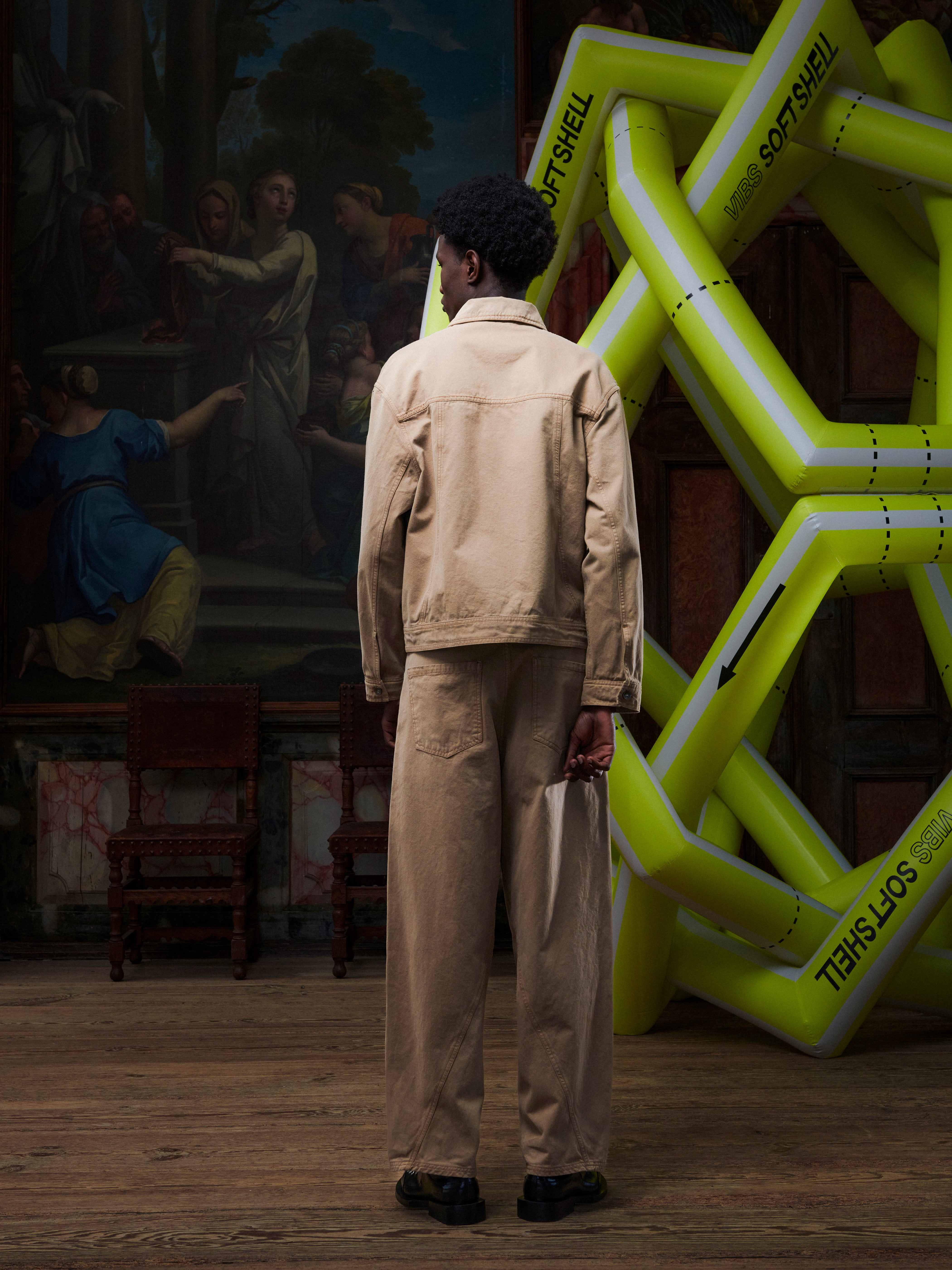 Back view of the male model wearing the Curved Denim Pants, highlighting the back pockets, seams, and straight silhouette. Model is 191cm tall and wears size M.