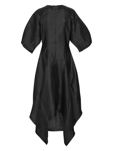Back view of the Double Bass Dress in Black, showing the fitted hourglass shape and the low–high hem from behind.