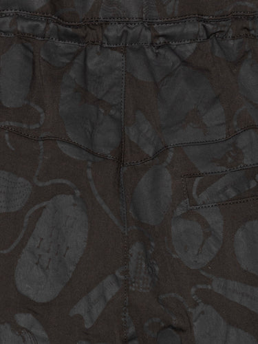 Close-up of the Drawstring Pants in Black Amulets, highlighting the textured black amulets pattern and the elastic waistband with drawstring.