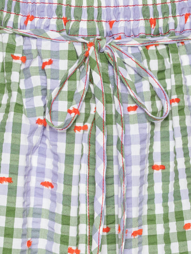 Close-up of the Drawstring Shorts in Checks Fillé, highlighting the purple and green checks, orange contrast stitching, and elastic waistband with drawstring.