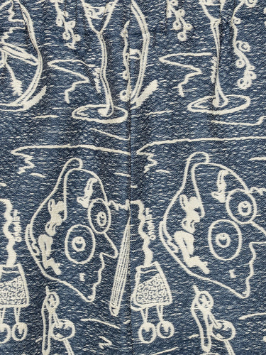 Close-up of the Henrik Vibskov Eclipse Pants in Henrik Doodle, highlighting the white embroidered doodles, fabric texture, and elastic waistband.