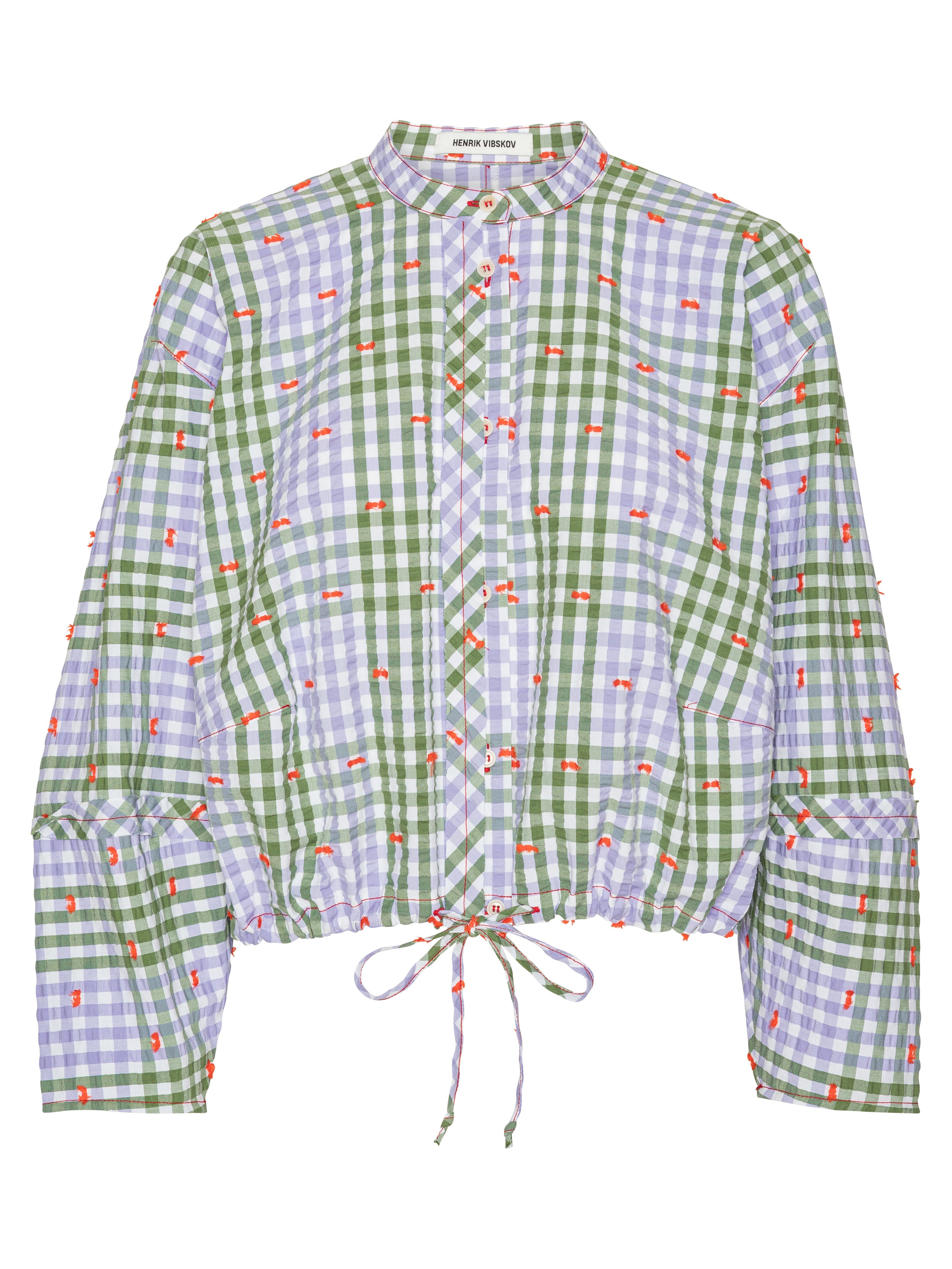 Front view of the Henrik Vibskov Flat Shirt in Checks Fillé, showing the purple and green check pattern, orange contrast stitching, round collar, front button closure, long sleeves, and cropped elastic hem with drawstring.