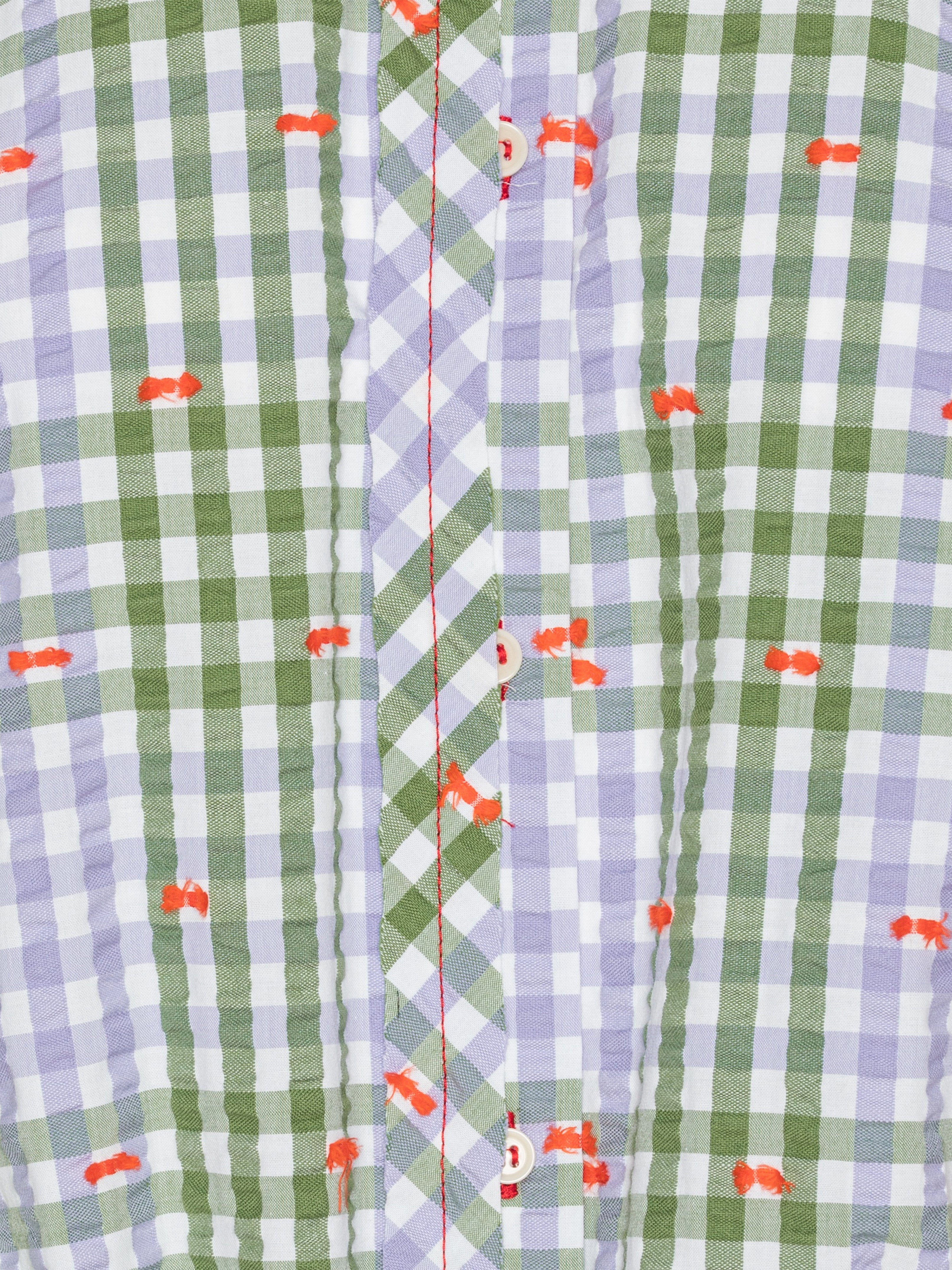 Close-up of the Henrik Vibskov Flat Shirt in Checks Fillé, highlighting the purple and green checks, orange stitching, and button details.