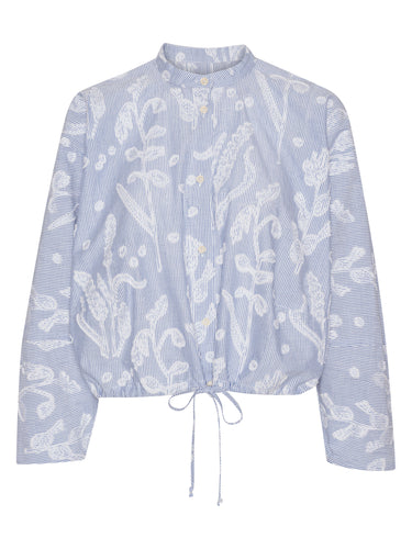 Front view of the light blue Flat Shirt with white distressed floral print, mandarin collar, front button closure, and elasticated hem.