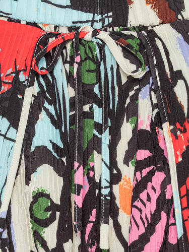 Close-up of the Henrik Vibskov Fold Plissé Pants in Carrots, highlighting the detailed root vegetable illustrations, pleated texture, and elastic drawstring waistband.