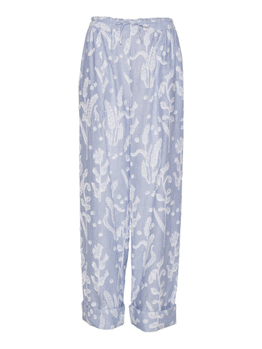 Front view of Henrik Vibskov Helmet Pants in light blue textured floral fabric with wide legs and elastic waistband with drawstring.