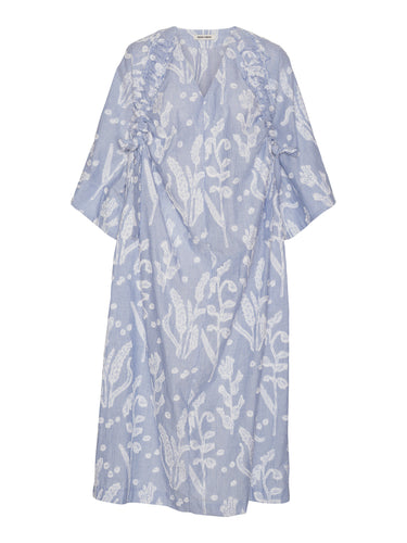 Front view of the Insurance Dress in light blue with white textured floral pattern, V-neck, short wide sleeves, and loose silhouette.