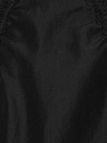 Close-up of the black Insurance Top highlighting the lightweight Tencel-linen fabric and sleeve with adjustable drawstring detail.