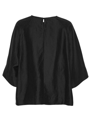 Back view of the black Insurance Top showing the relaxed oversized fit and straight hem.