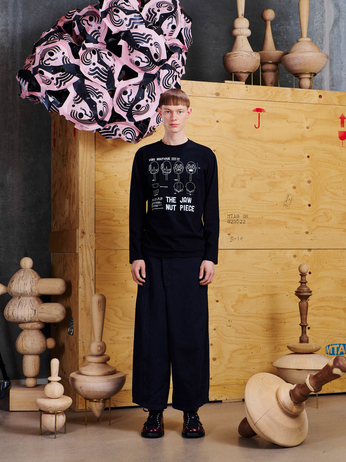 Model wearing Henrik Vibskov Jaw Nut Piece Tee in Black with crew neckline, long sleeves, white archive-inspired print and straight hem