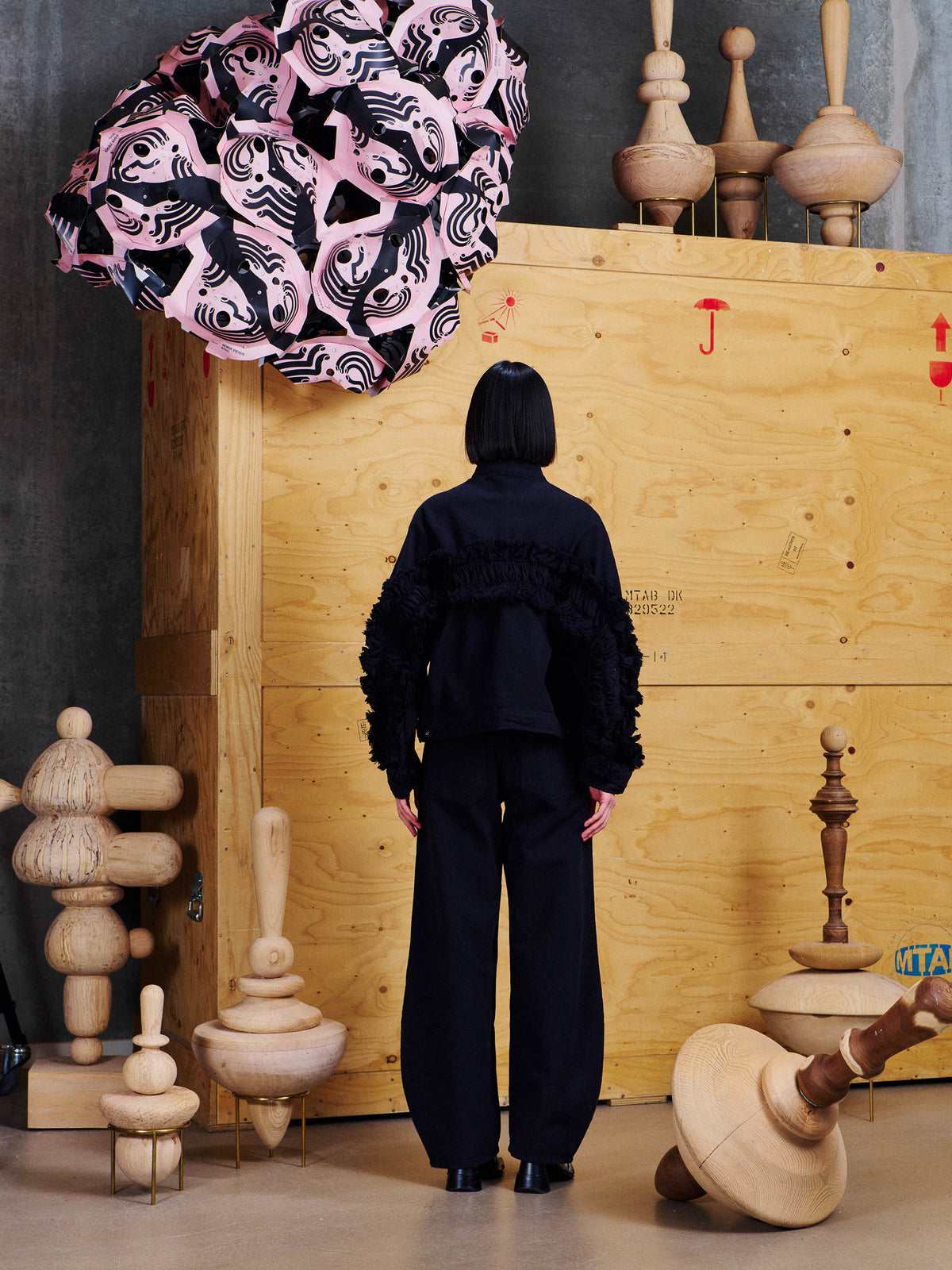 Back view of model wearing the Henrik Vibskov Johnny Jacket in Black, showing textured fringe detailing extending across the back and sleeves.