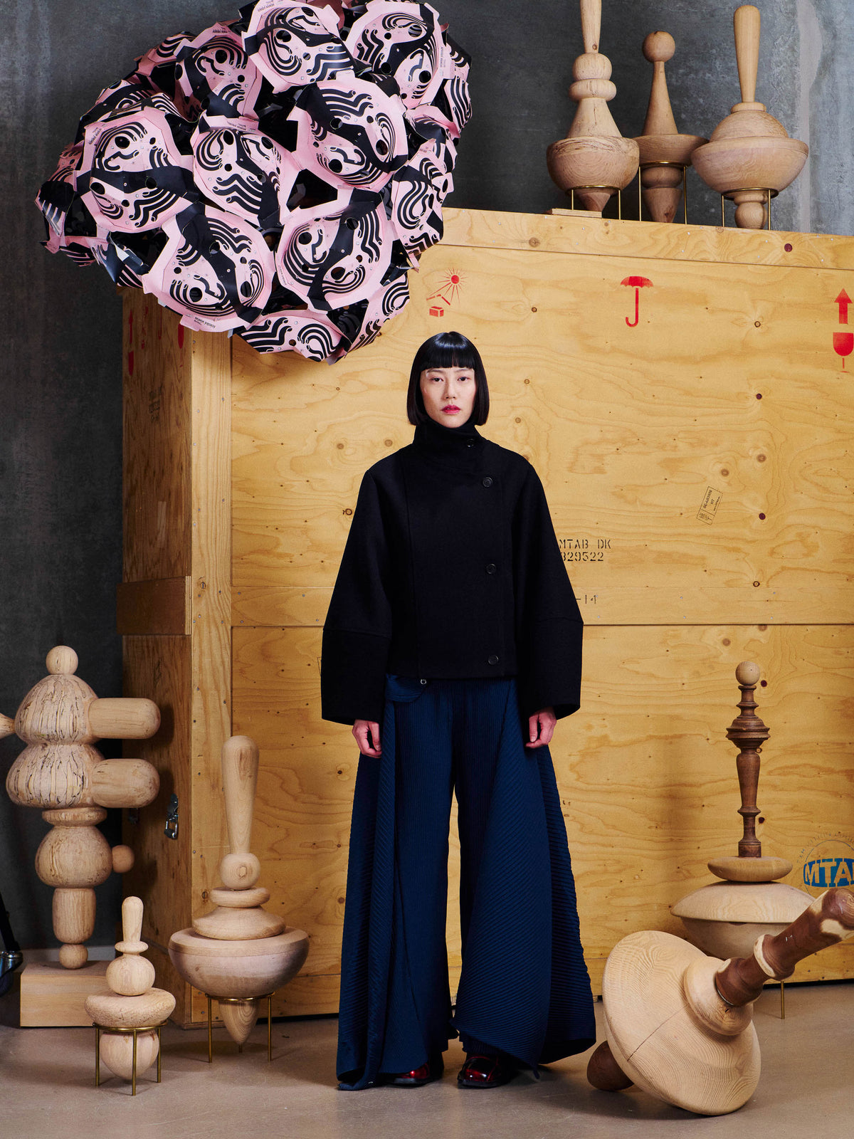 Front view of model wearing the Henrik Vibskov Moon Short Jacket in Black, styled closed to show the structured cropped shape and high neckline.
