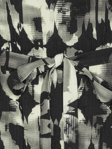 Close-up of the Henrik Vibskov New Pina Plissé Dress in Bursting Eggs, highlighting the abstract egg illustration and pleated plissé texture.