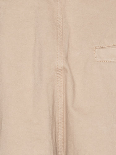 Close-up of the Henrik Vibskov Open Dart Pants in sand beige, highlighting the pleated front, button fly, and fabric texture.