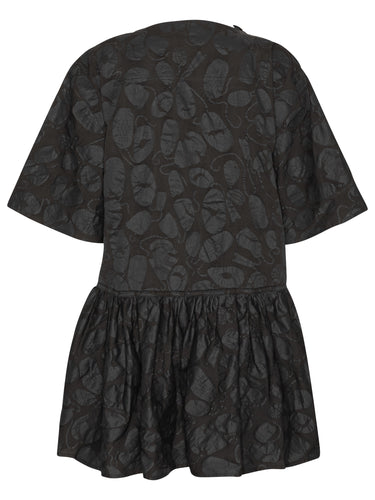 Back view of the Henrik Vibskov Preserve Blouse in Black Amulets, showing the oversized silhouette, short sleeves, and wide, knee-length skirt.