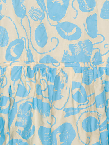 Close-up of the Henrik Vibskov Preserve Blouse in Ecru Amulets, highlighting the blue amulet pattern, V-neck with button detail, and fabric texture.