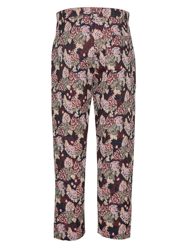 Back view of floral and chicken patterned pants by Henrik Vibskov on a white background