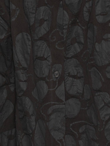 Close-up of a black-on-black pattern, sleeveless dress from Henrik Vibskov