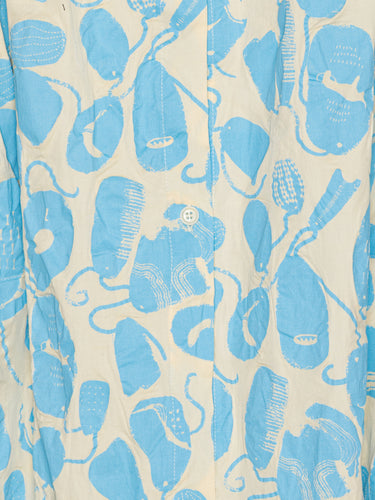 Close-up of a light blue abstract pattern on a off-white material.
