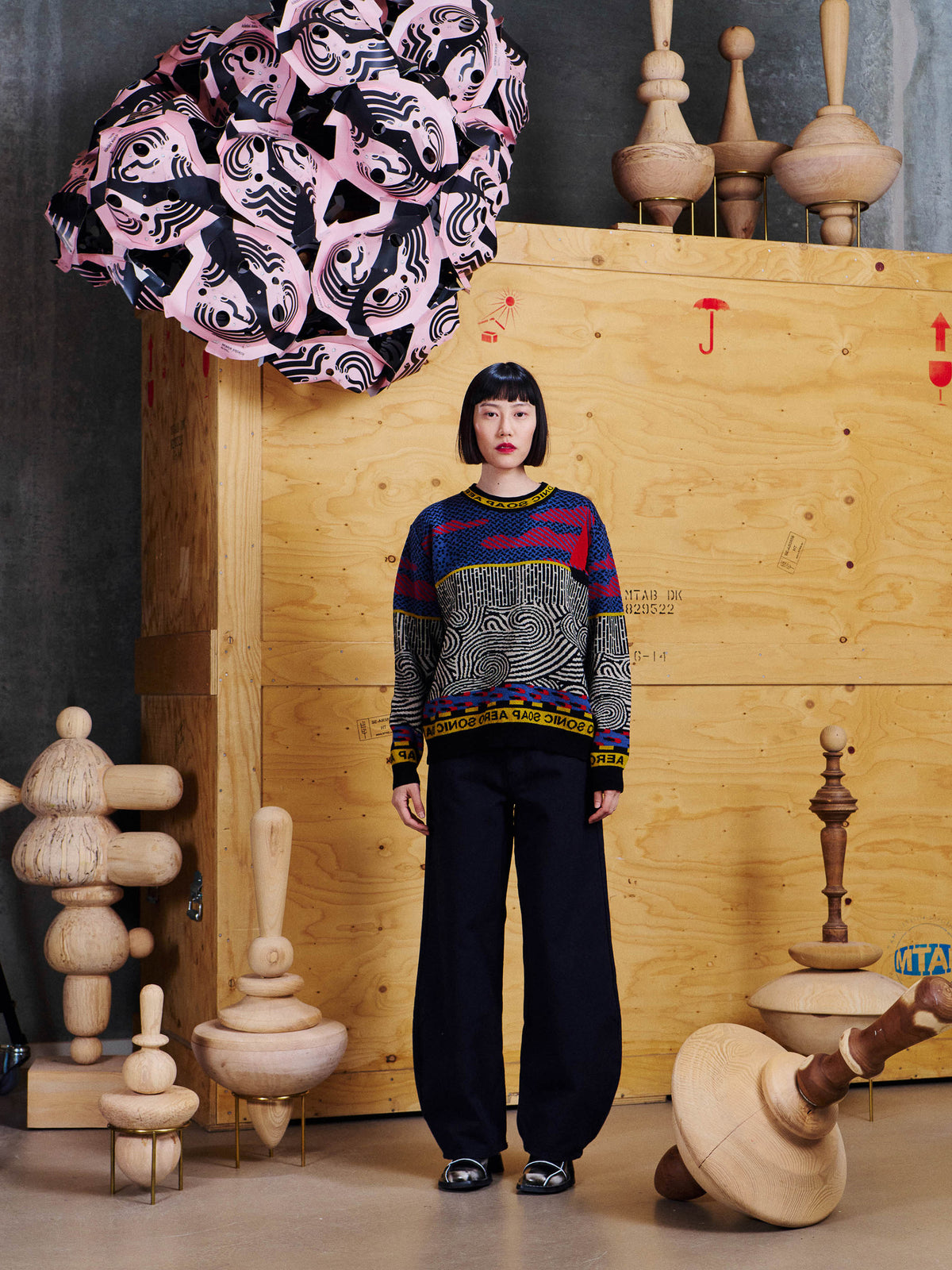 Model wearing Henrik Vibskov Sail Knit Sweat in Stormy Sea from the front, showing the relaxed fit and mixed graphic jacquard pattern.