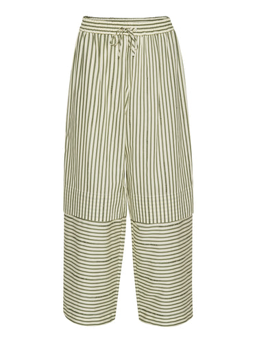 Front view of the Shants Pants in green and off-white stripes with subtle text, showing elastic waistband, drawstring, and wide legs with layered detailing.