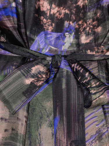 Multicolored fabric with a purple fox design on a textured background