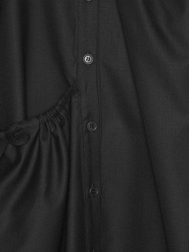 Close-up of a black button-up shirt dress with a drawstring detail.