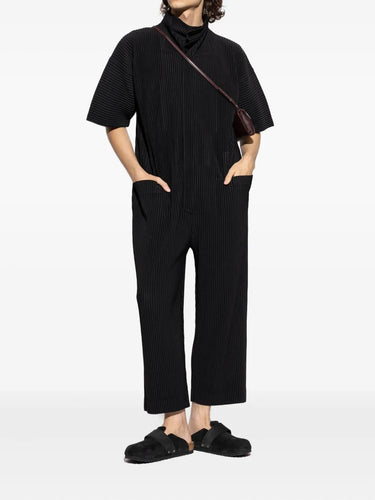 Person wearing a black outfit with a white background