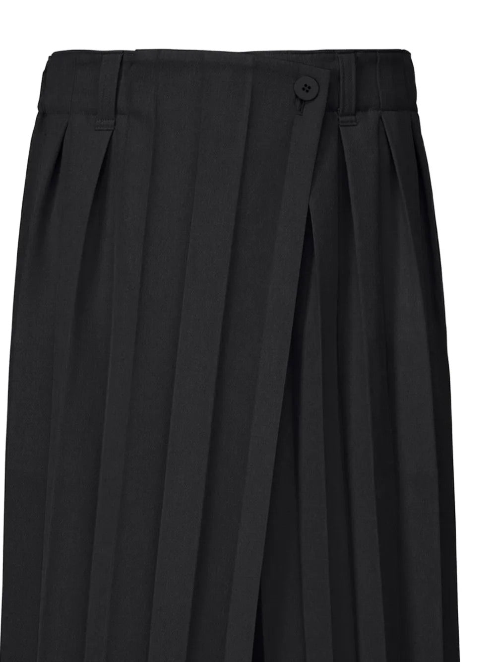 Closeup of black wide-pleat wrap trousers by Homme Plissé Issey Miyake, detail of structured pleating and wrap-style front on black fabric, white background