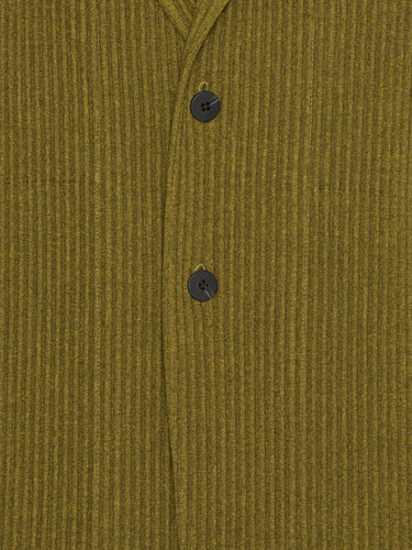 Close-up of a mossy yellow-green plissé blazer from Homme Plissé Issey Miyake