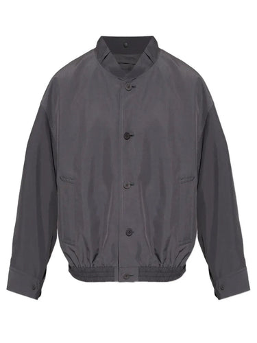 Front view of the Homme Plissé Issey Miyake January Carrier Carried Blouson in charcoal, featuring a high neck, front button closure, side pockets, and straight elastic hem.