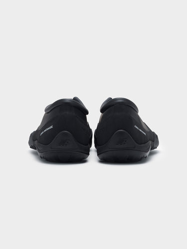 Junya Watanabe x New Balance MT10T sneakers in black, back view of pair, Junya Watanabe branding and New Balance heel logo